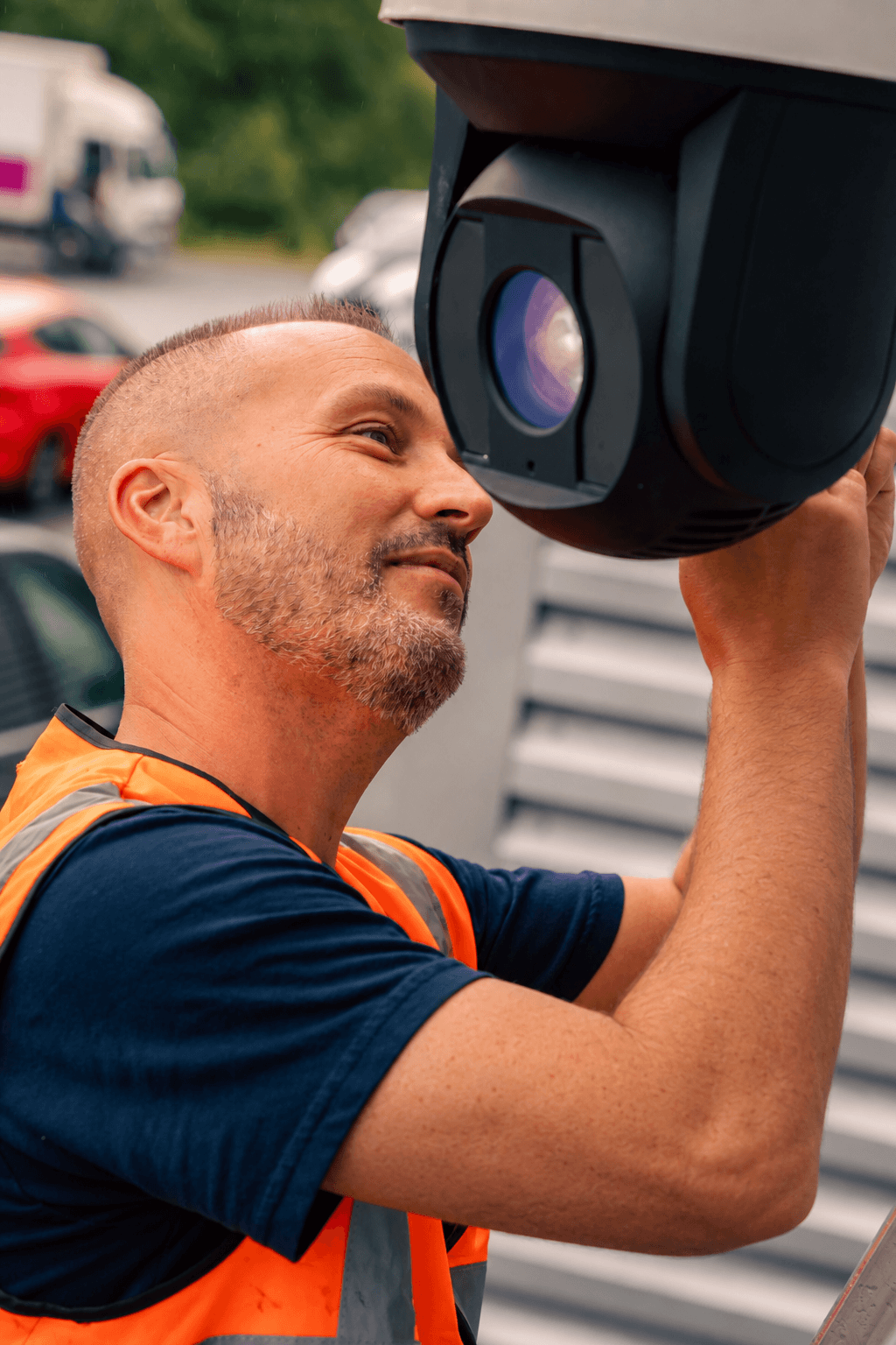 AYS Security technician installing and adjusting a commercial PTZ dome camera